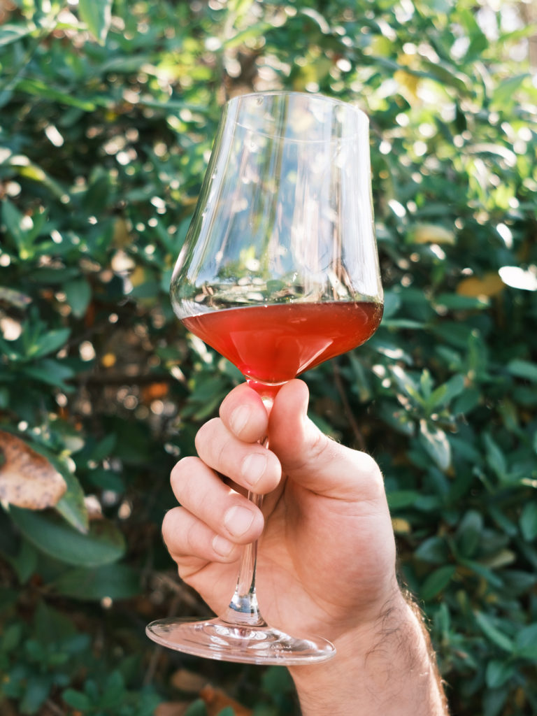 Hand holding glass of Noblemen Wine